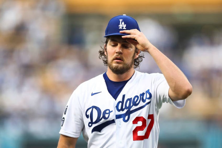 Trevor Bauer of the Los Angeles Dodgers returns to the dugout after the top of the first inning against the San Francisco Giants at Dodger Stadium on...