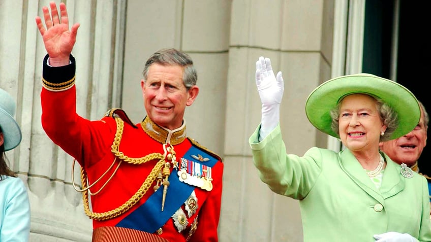 Queen Elizabeth and her son, the now King Charles III, happily waved at the crowd while on the Buckingham Palace balcony.