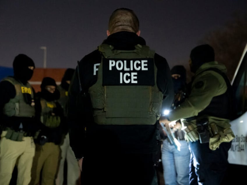U.S. Immigration and Customs Enforcement officers gather for a briefing before an enforcem