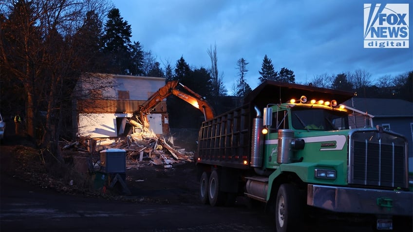 Construction vehicles demolishing the Idaho home.