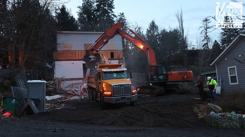 Construction vehicles demolishing the Idaho home.