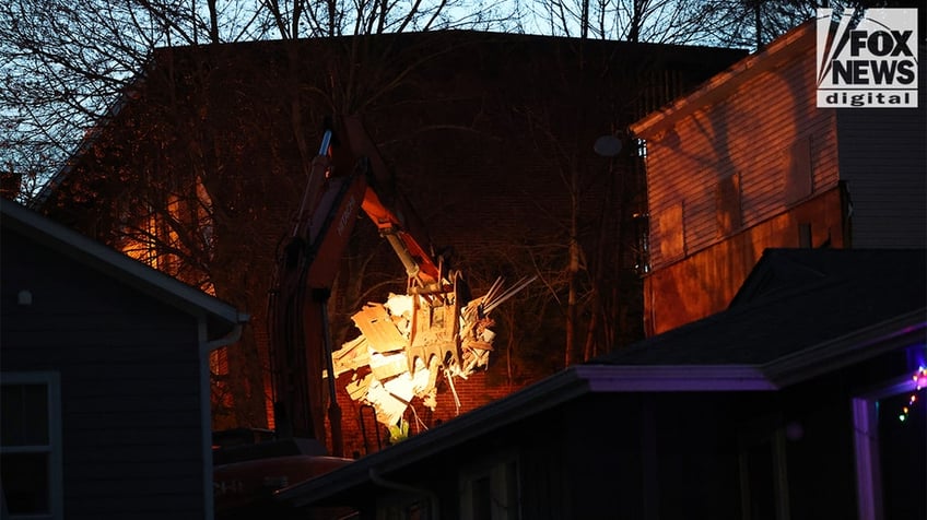 Construction vehicles demolishing the Idaho home.