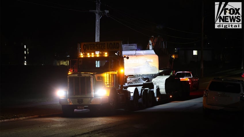 Construction vehicles demolishing the Idaho home.