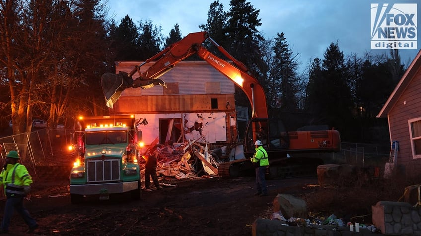 Construction vehicles demolishing the Idaho home.