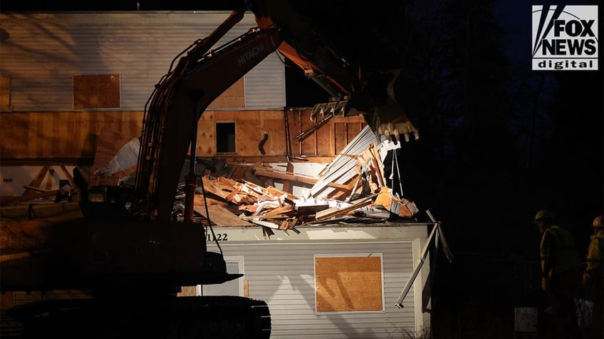 Construction vehicles demolishing the Idaho home.