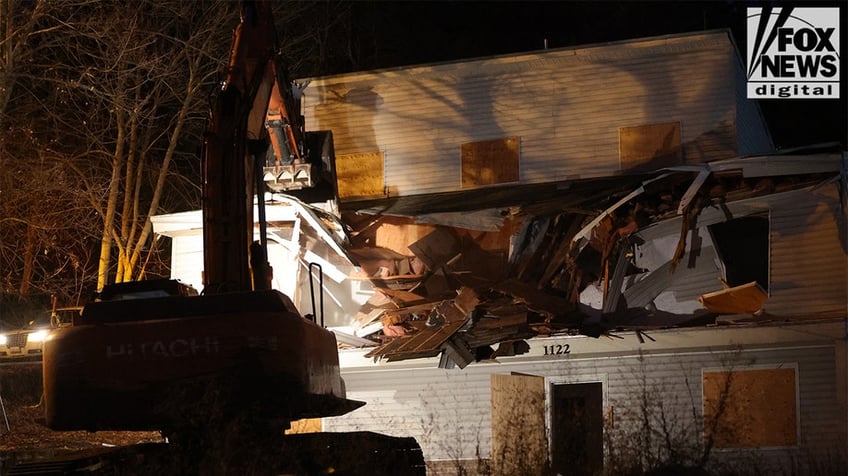 Construction vehicles demolishing the Idaho home.