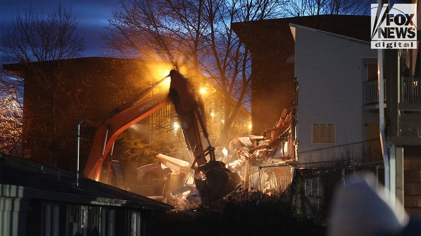 Construction vehicles demolishing the Idaho home.