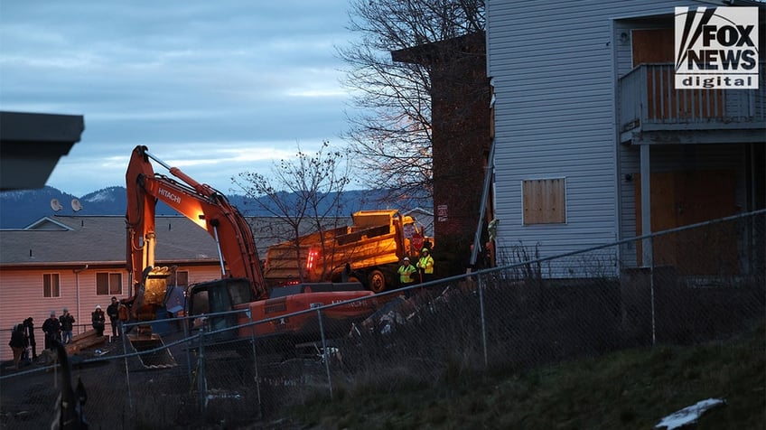 Construction vehicles demolishing the Idaho home.