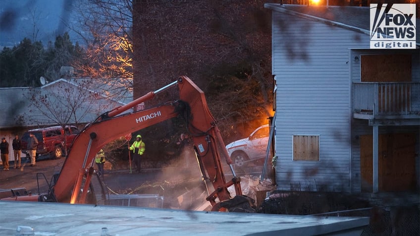 Construction vehicles demolishing the Idaho home.