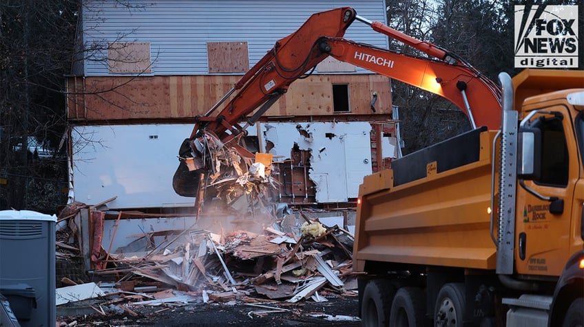 Construction vehicles demolishing the Idaho home.