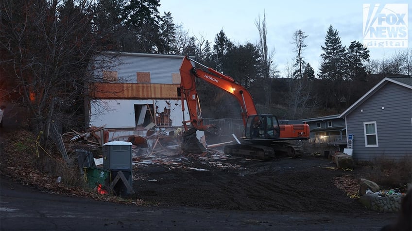 Construction vehicles demolishing the Idaho home.