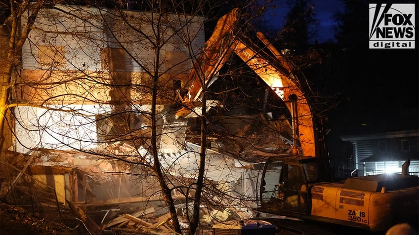 Construction vehicles demolishing the Idaho home.