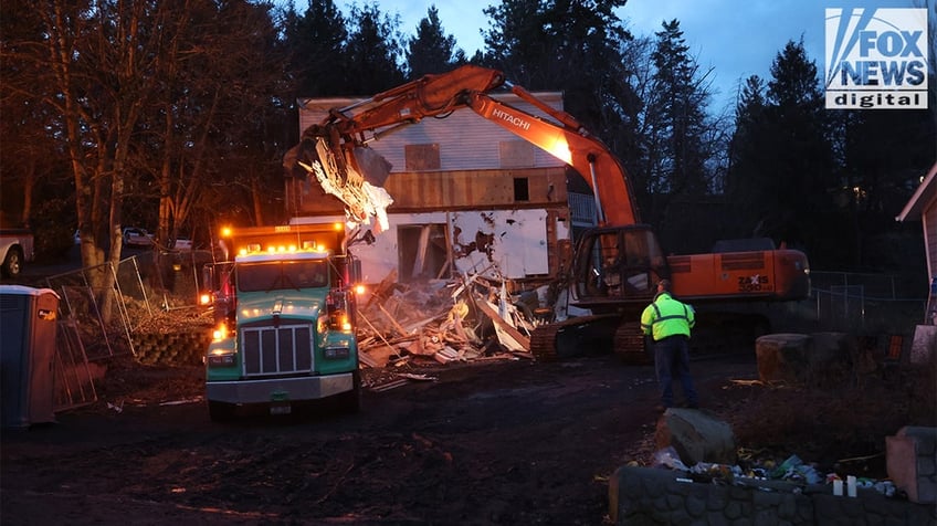 Construction vehicles demolishing the Idaho home.