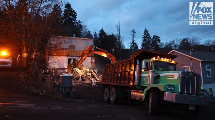 Construction vehicles demolishing the Idaho home.