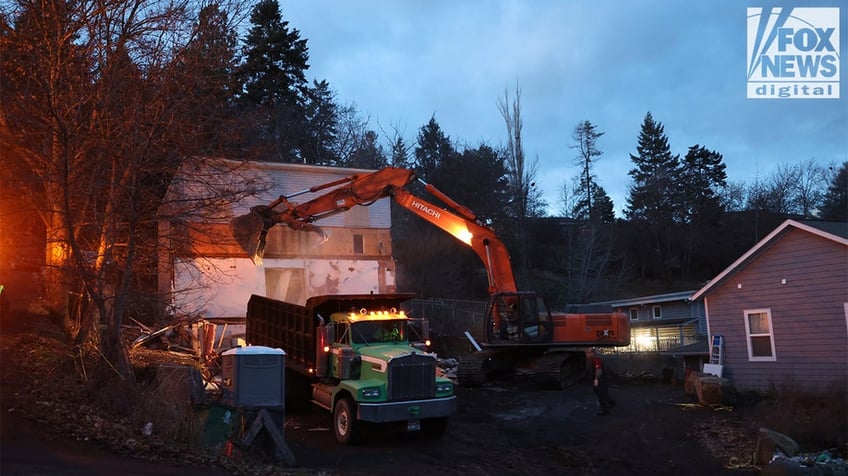 Construction vehicles demolishing the Idaho home.