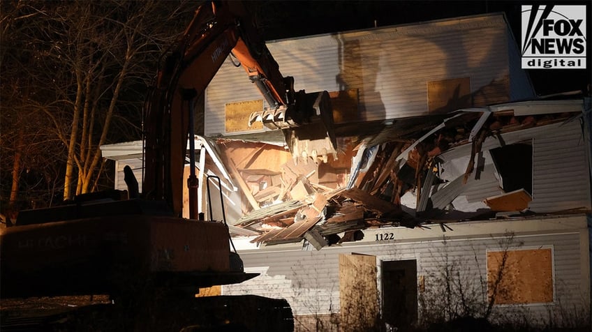 Construction vehicles demolishing the Idaho home.