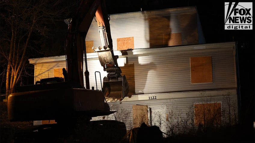 Construction vehicles demolishing the Idaho home.