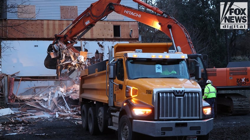 Construction vehicles demolishing the Idaho home.