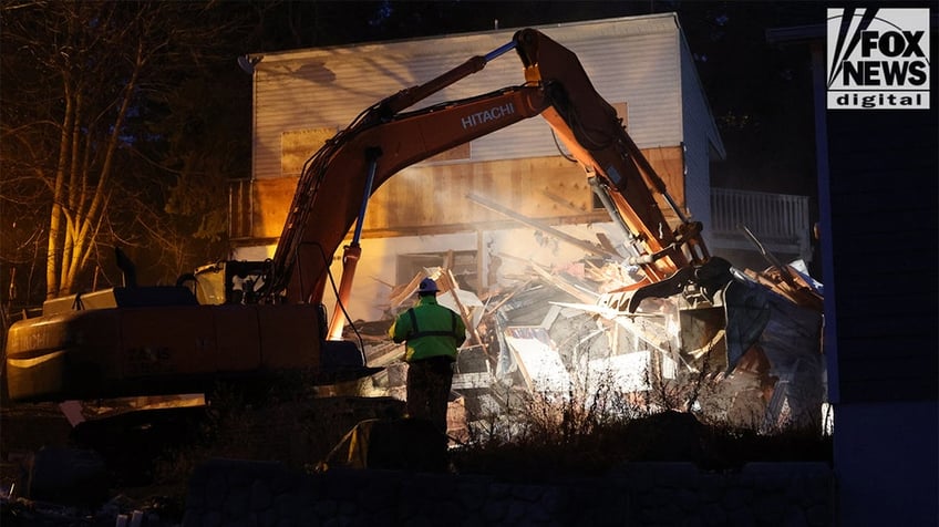 Construction vehicles demolishing the Idaho home.