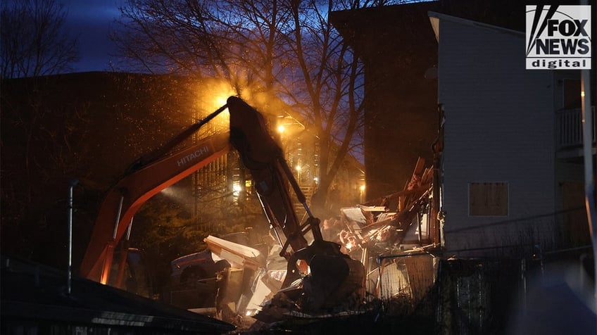 Construction vehicles demolishing the Idaho home.