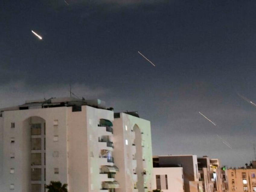 Israeli Iron Dome air defense system launches to intercept missiles fired from Iran, in ce