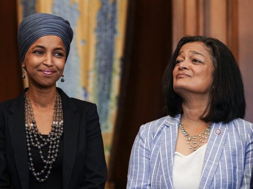 Reps. Ilhan Omar (D-MI) and Pramila Jayapal (D-WA) listen as Speaker of the House Nancy Pe