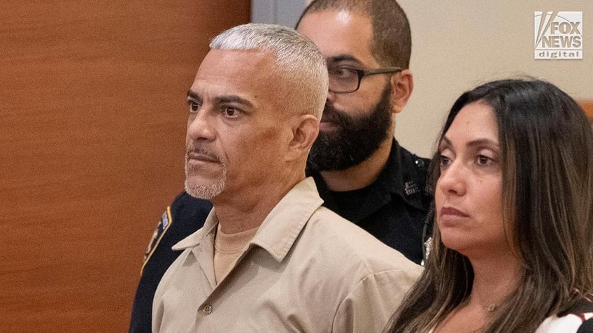 Man in prison uniform in court