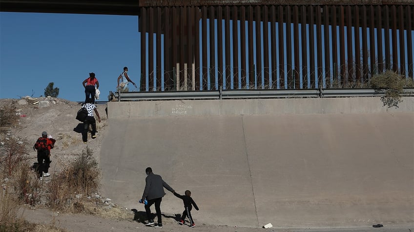 Families cross the Rio Bravo river illegally