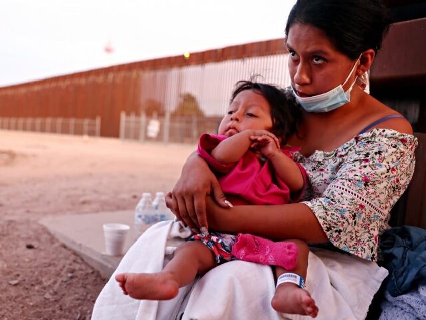 SAN LUIS, ARIZONA - MAY 23: An immigrant mother holds her one-year-old son, after they wer