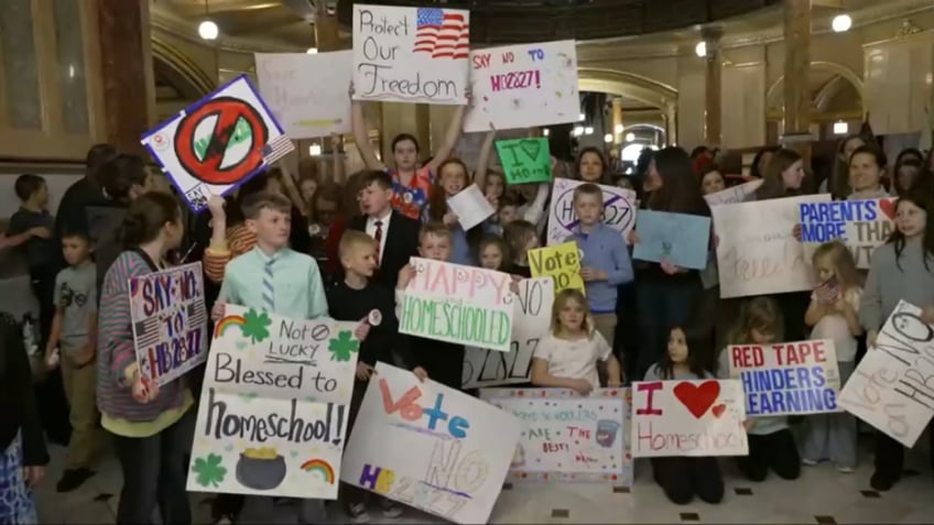 Illinois capitol protesters hold signs in support of homeschooling