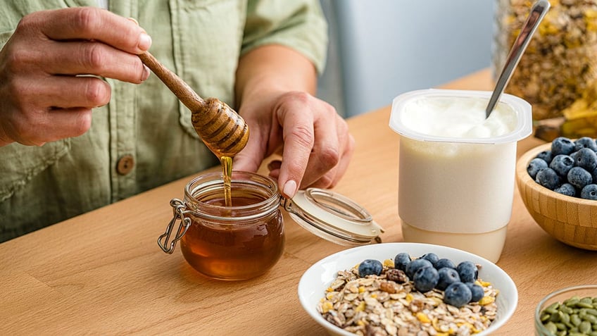 healthy breakfast with honey, berries, seeds, granola and yogurt.