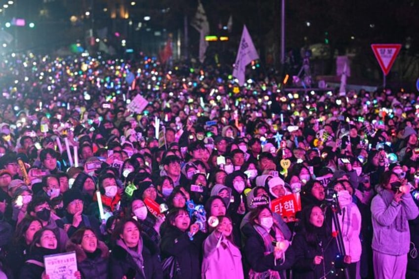 Protesters calling for the ouster of President Yoon Suk Yeol react after the result of the