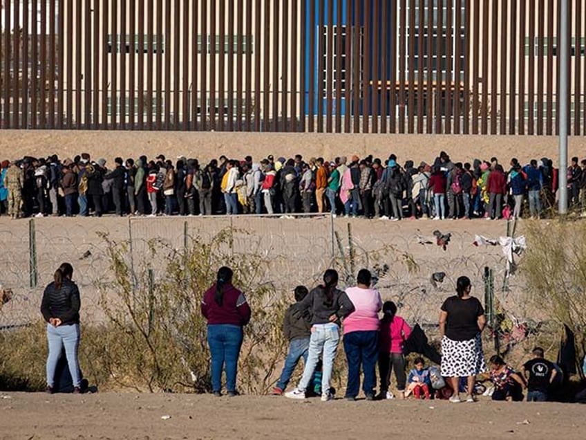 Migrants wait in front of barbed wire as hundreds of migrants are attempting to reach the United States border to seek humanitarian asylum in Ciudad Juarez, Mexico on December 29, 2023. Despite the efforts of the Texan National Guard, the migrants managed to traverse the river and overcome obstacles, including …