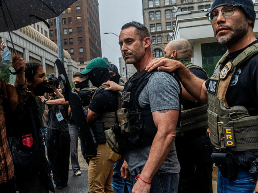 Protestors and ICE agents stand face to face in a tense standoff outside 26 Federal Plaza