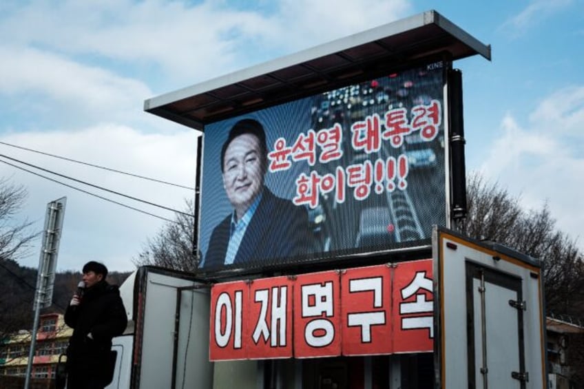 A supporter of impeached South Korean President Yoon Suk Yeol speaks near his residence in