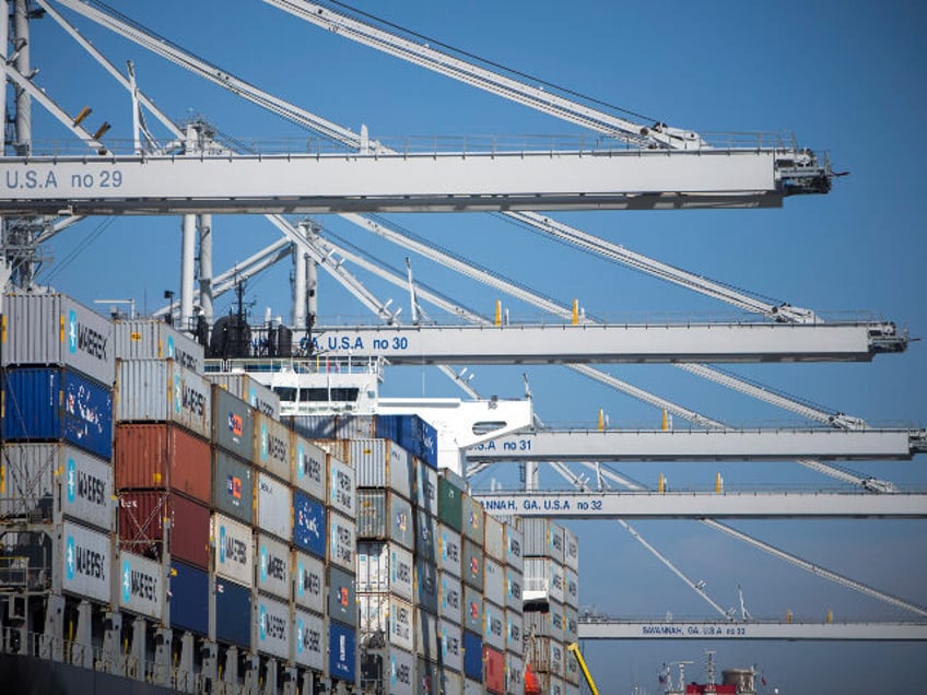 The container ship Northern Javelin is worked by ship to shore cranes at the Port of Savan