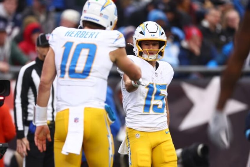 Ladd McConkey of the Los Angeles Chargers celebrates with quarterback Justin Herbert after