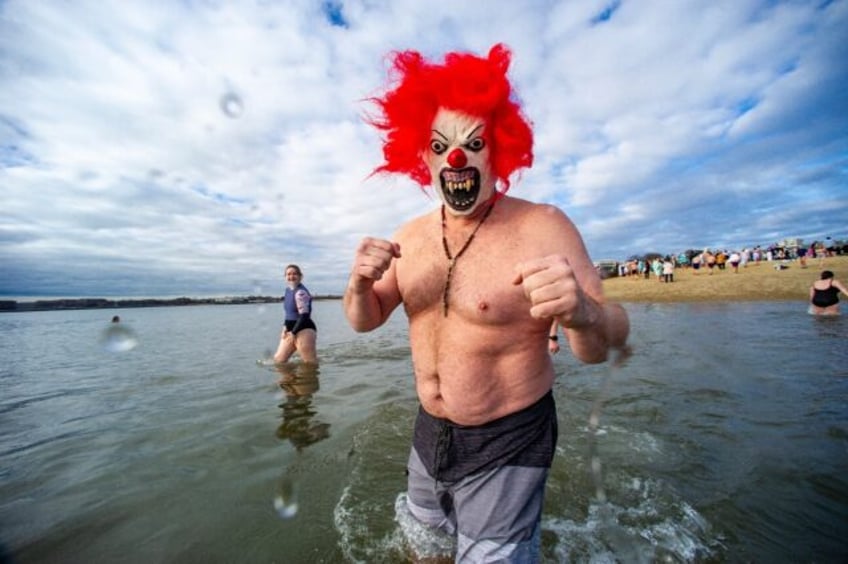 Revelers take part in the annual L Street Brownies’ cold water plunge in Boston on New Year’s Day, January 1, 2024