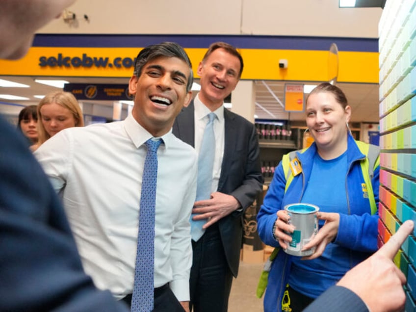 LONDON, ENGLAND - MARCH 06: UK Prime Minister Rishi Sunak, left smiles with UK Chancellor