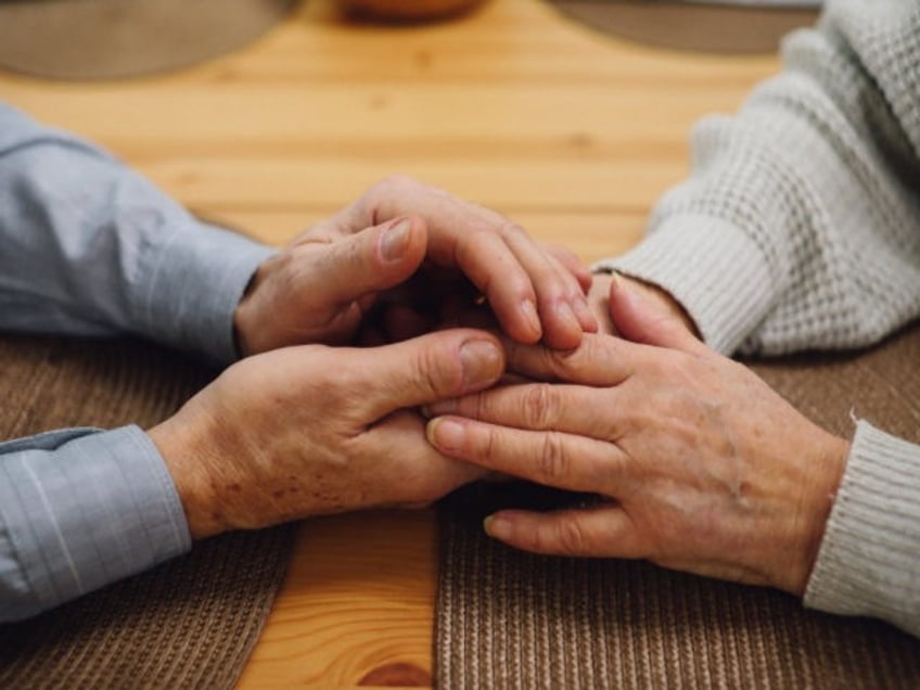 Old couple holding hands