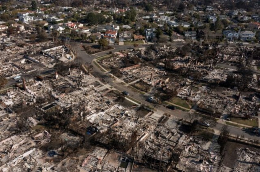 An aerial image shows homes damaged and destroyed by the Palisades Fire in the Pacific Pal