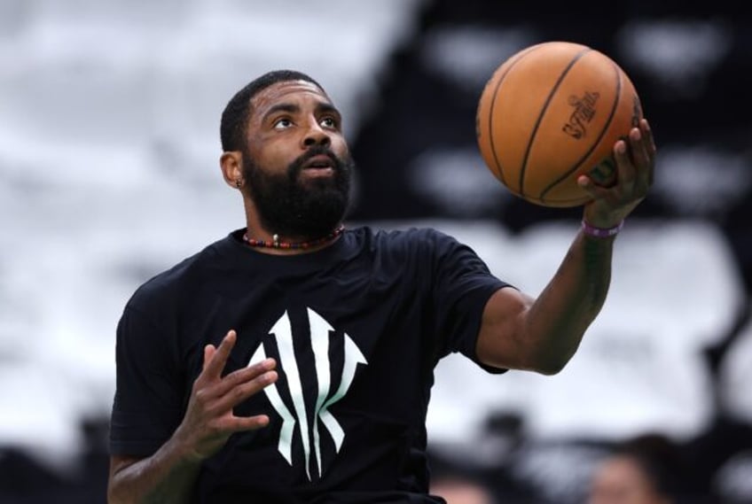 Dallas star Kyrie Irving warms up before game two of the NBA Finals against Boston