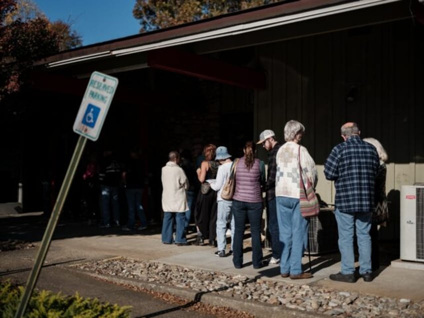 Voters line up in Black Mountain, in hurricane-ravaged North Carolina, to cast their ballo