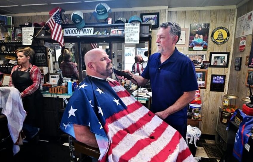 Woody Clendenen, 57, shaves customer Ben Duncan at his barbershop in California's Shasta C