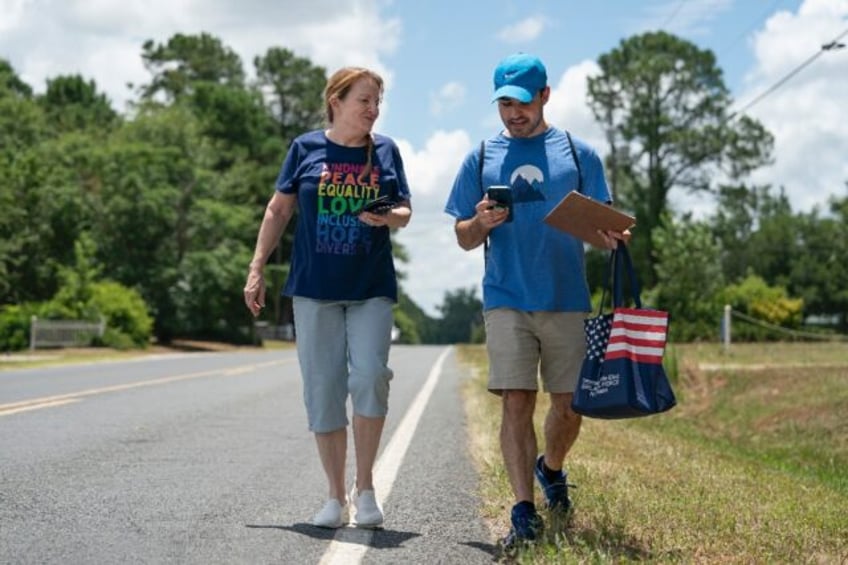 Democratic Party activists Darah Hardy (L) and Yampiere Lugo (R) canvass voters in Laurinb