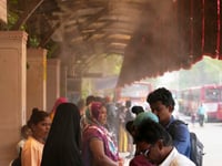 In one Indian city, reflective paint and bus stop sprinklers offer relief from killer heat
