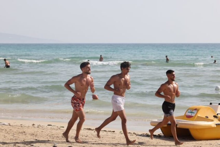 People spend the day on the beach in the port city of Tyre in southern Lebanon despite fea