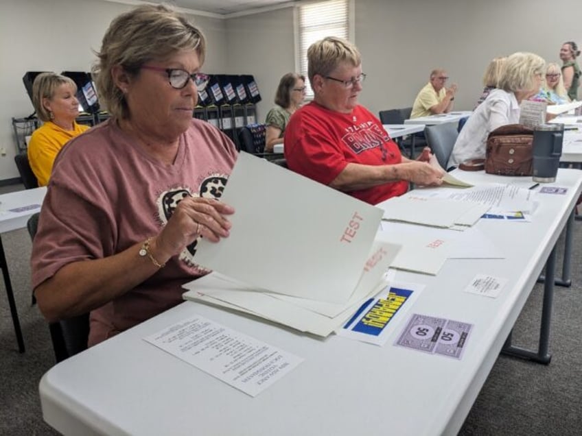 Lee County, Georgia poll workers Debbie Jack (L) and Donna Mathis (R) practice counting ba