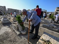 In Syria’s devastated Jobar, cemetery comes alive for Eid