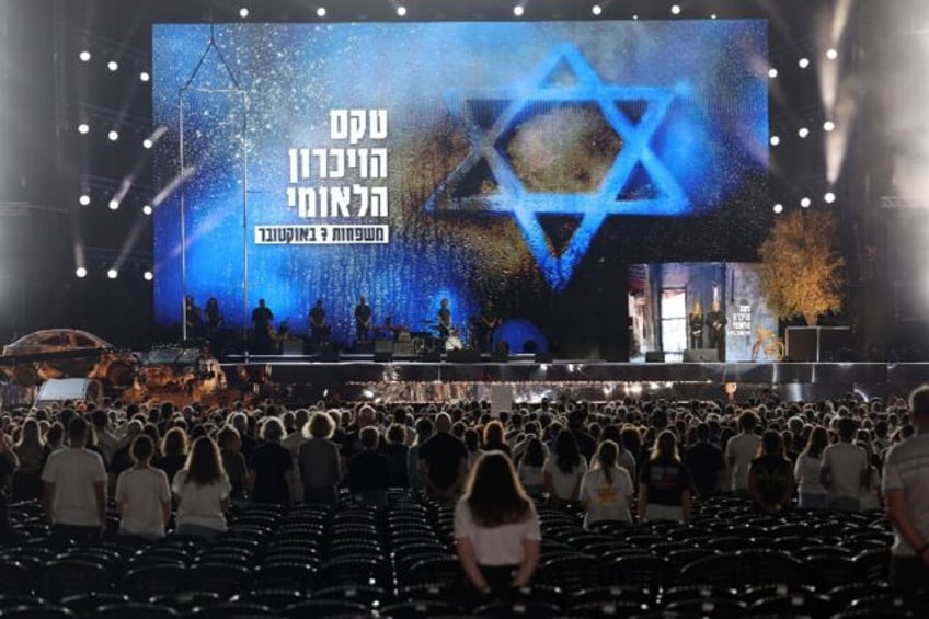 Participants at the memorial observe a moment's silence during the ceremony